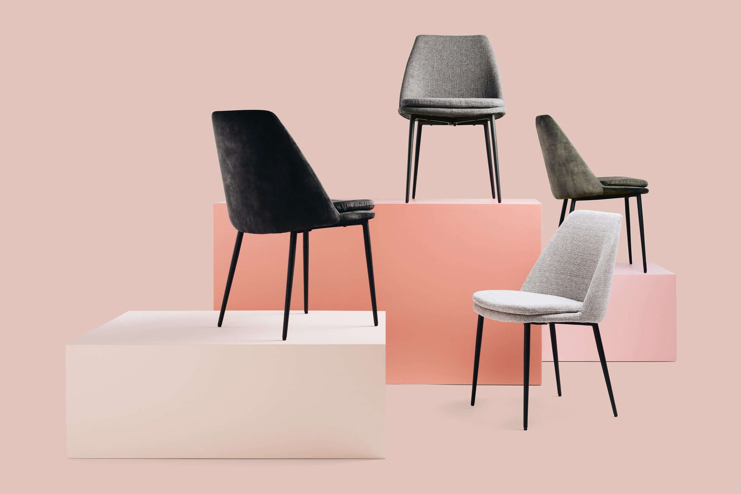 Mia Dining Chairs on display, featuring cushioned seats in rich woven fabric and sleek metal legs, perfect for luxury dining rooms.