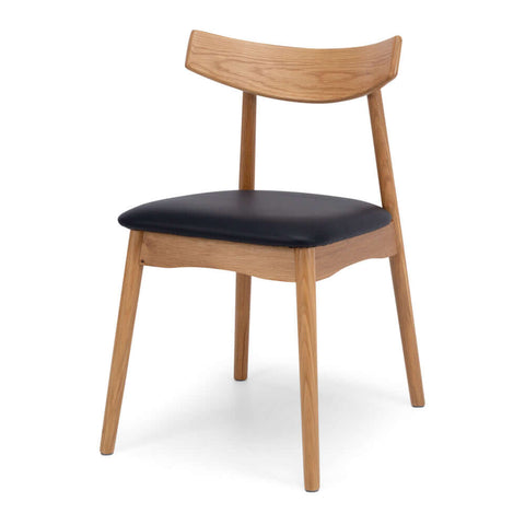 Natural oak dining chair with a black upholstered seat and curved backrest on a white background, shown from an angled view