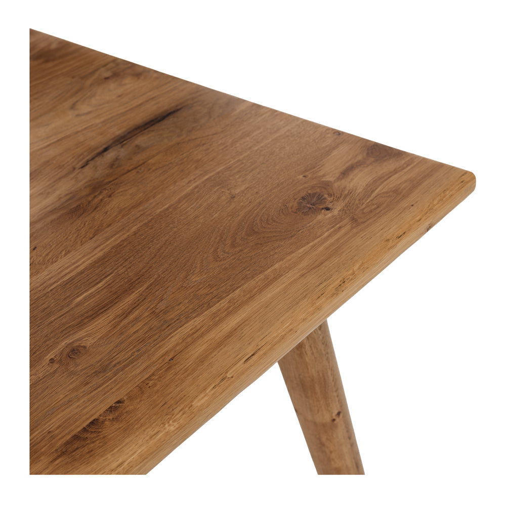 
                      
                        Close-up of Reeves Dining Table showcasing solid smoked oak with natural grain and tapered legs.
                      
                    