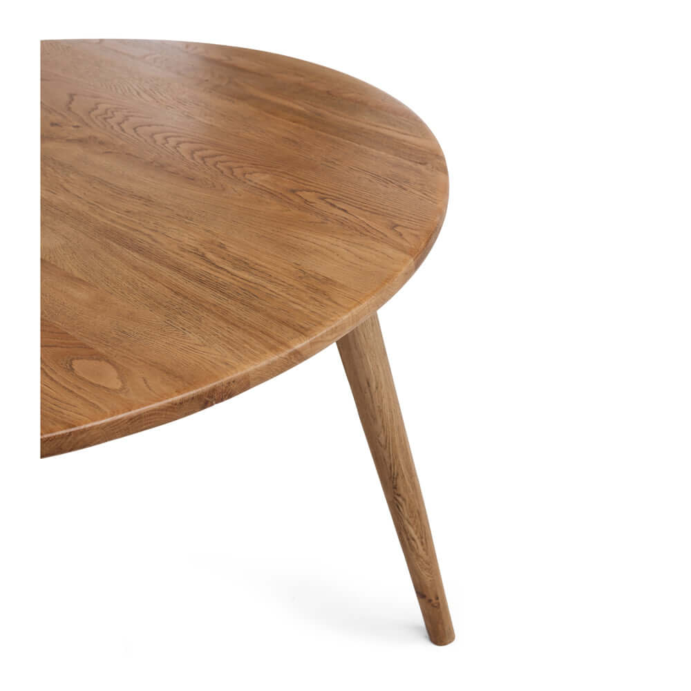 
                      
                        Reeves Dining Table round design in solid smoked oak showcasing natural grain and tapered legs.
                      
                    