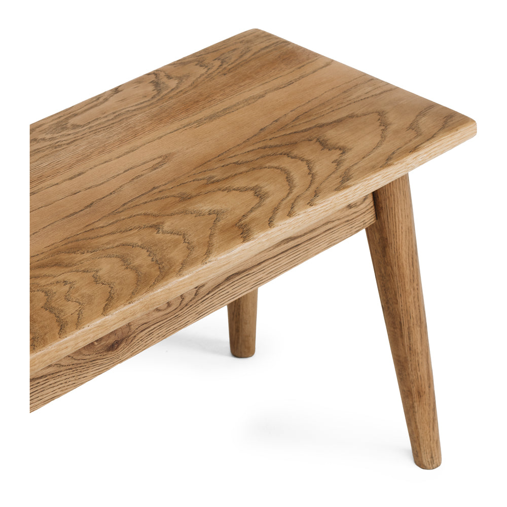 
                      
                        Reeves Dining Bench in solid smoked oak showcasing a natural grain and tapered legs for elegant, sturdy design.
                      
                    