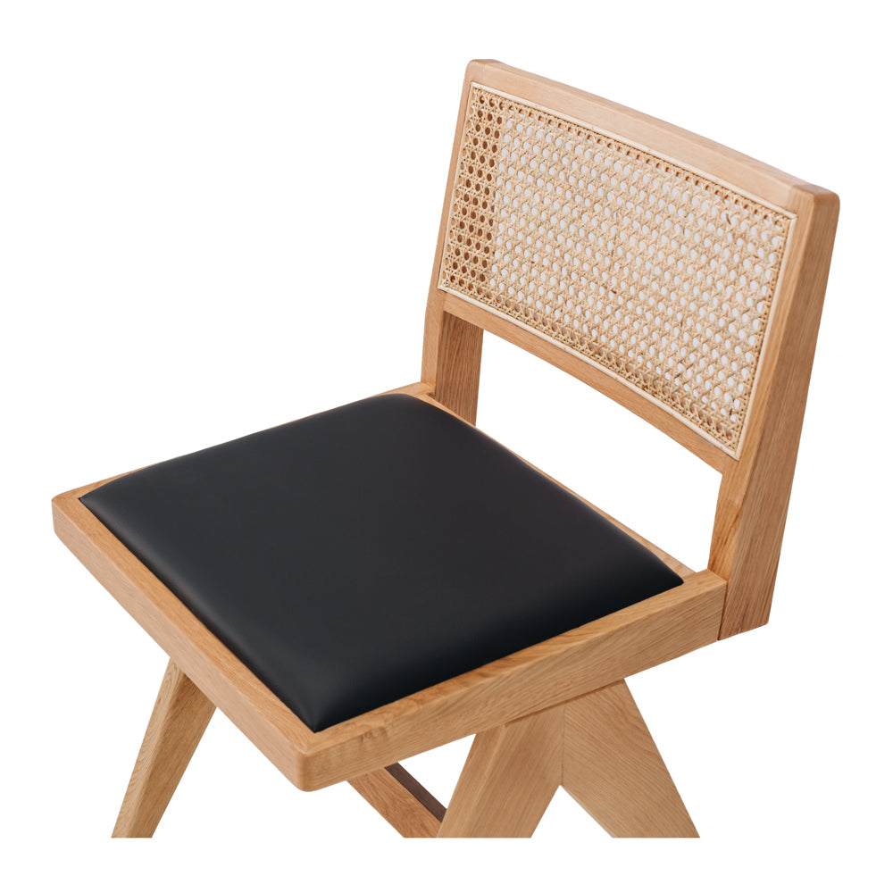 
                      
                        Palma Dining Chair with black padded seat, Japandi style, solid oak frame, and rattan backrest, blending Japanese minimalism and Scandinavian design.
                      
                    