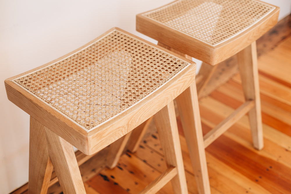 
                      
                        Oak and rattan Palma bar stool with Japandi design, featuring solid oak structure and woven rattan seat for minimalist seating.
                      
                    