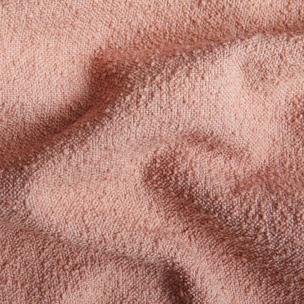 
                      
                        Close-up of blush-colored boucle fabric texture for Junior Boucle Cushion, showcasing its soft, curled surface in 95% polyester, 5% acrylic.
                      
                    