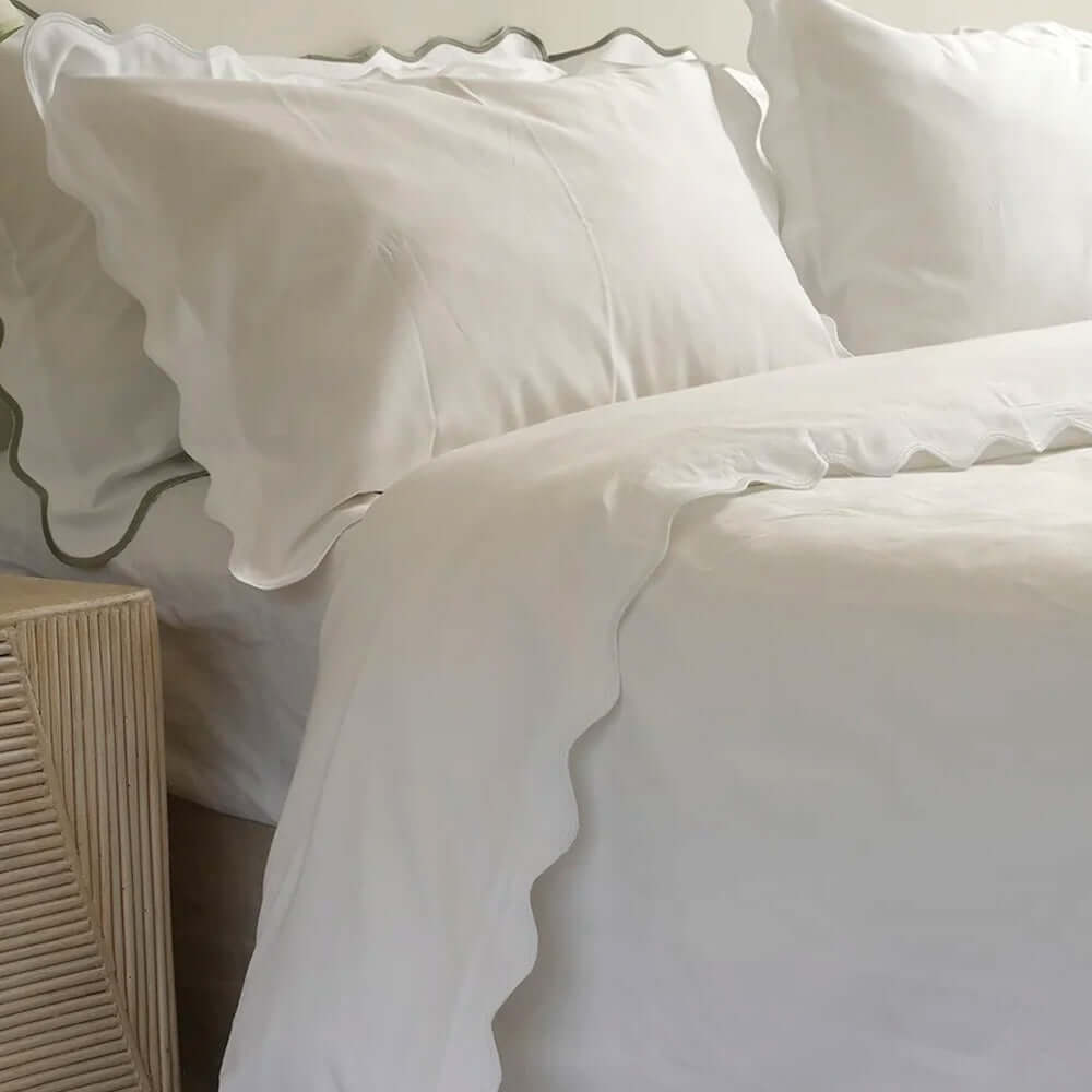 Luxurious Celine Duvet Set with scallop edges in soft white cotton percale sateen, adds elegance to your bedroom decor.