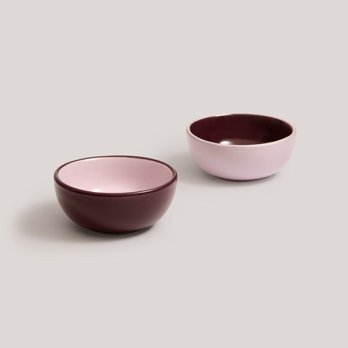 Hommey dip bowls in boysenberry and pink on a white background