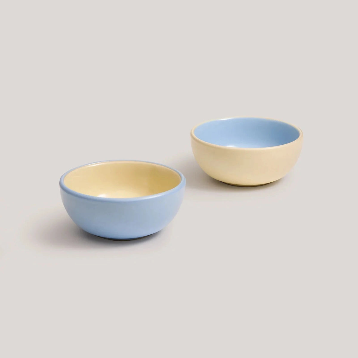 Hommey dip bowls in butter and blue, on a white background