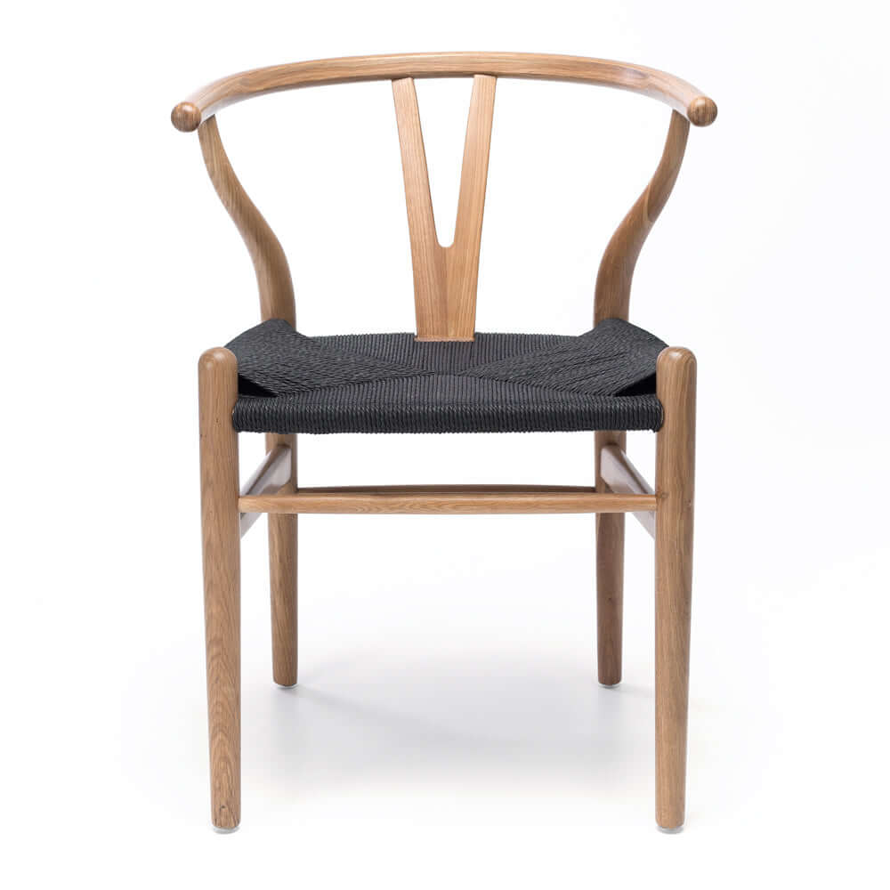 
                      
                        Replica Hans Wegner Wishbone Dining Chair with natural woodgrain oak and black rope seating, mid-century modern design
                      
                    