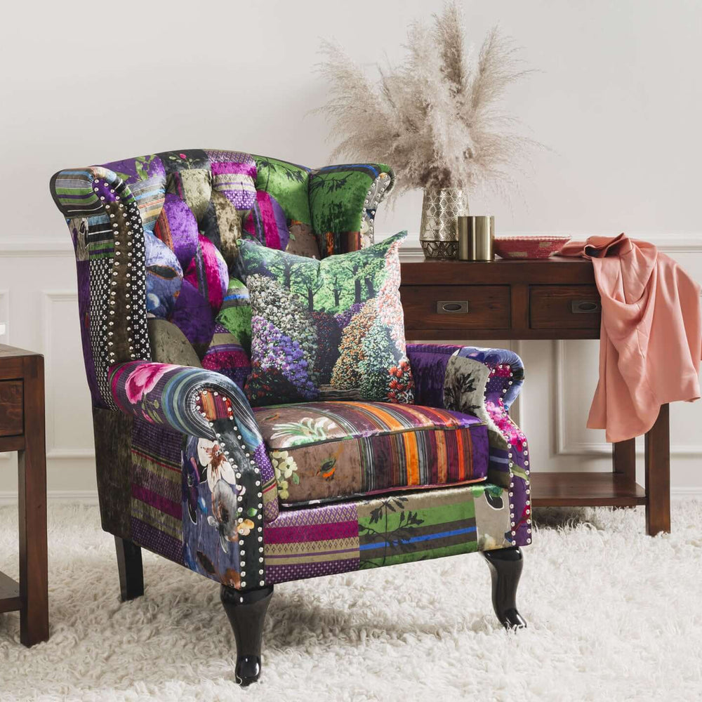 
                      
                        Patchwork wingback armchair with velvet fabric and glossy black legs, set in a colorful living room.
                      
                    