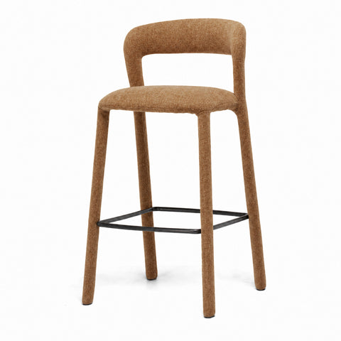 Gold fully upholstered barstool with a curved backrest on a white background, shown from an angled view

