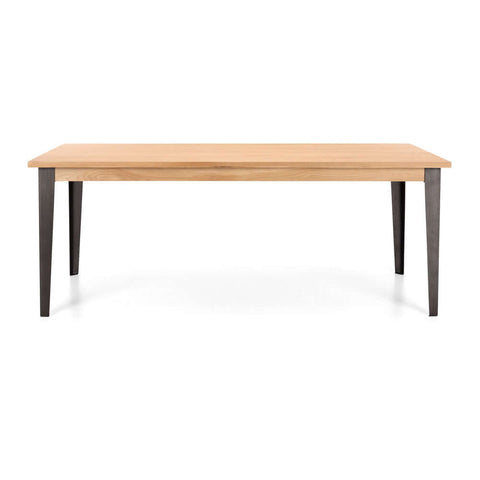 Karel solid oak dining table with brushed metal legs, angled view