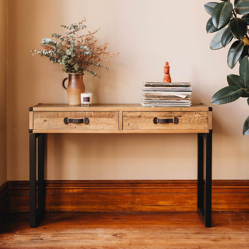 
                      
                        Woodenforge Hall Table with decor, crafted from eco-friendly reclaimed wood, featuring two drawers and metal legs for a rustic look.
                      
                    