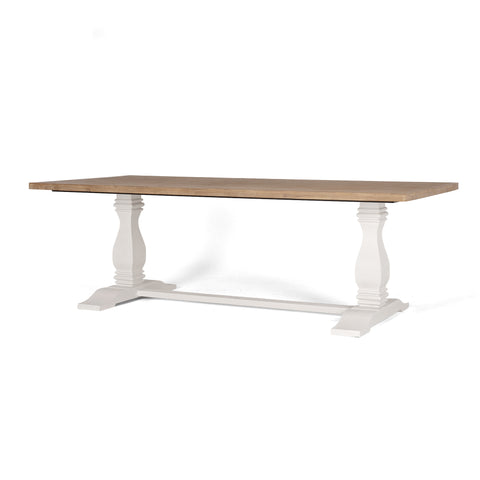 Soft white finished Acacia wood dining table with a natural, brushed Acacia wood top and two pedestal bases, on a white background, shown from an angled view